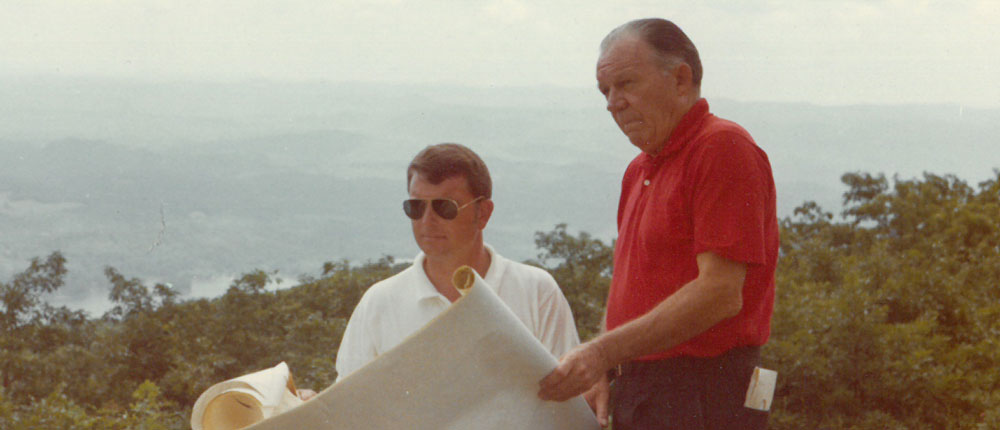 Howerdd Sr. and Howerdd Jr looking over golf course plans